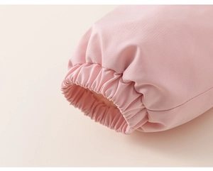 Close-up of the pink toddler jacket featuring elastic cuffs and twill fabric texture