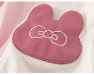 Close-up of cute rabbit embroidery on pink and beige fleece winter hoodie for girls