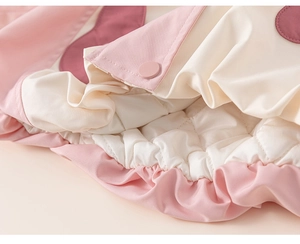 Close-up of diamond quilted lining and pink elastic cuff on kids warm winter coat