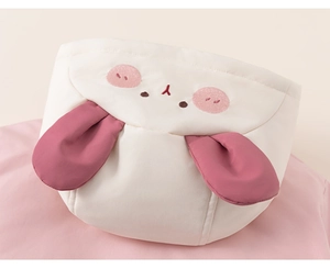 Close-up of cute cartoon rabbit hood with pink ears on white padded winter coat for girls