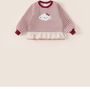 Close-up of girls' red striped sweatshirt featuring a fuzzy puppy patch and ruffle hem detail