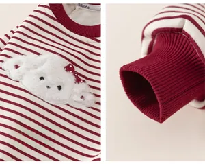 Detail of red striped pet sweater featuring plush puppy appliqué and ribbed elastic cuffs