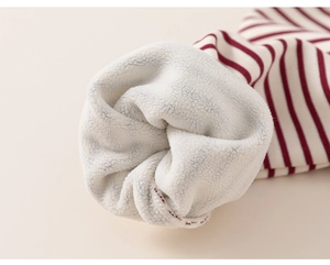Detail of red and white striped kids sweatshirt with soft white fleece lining for warmth