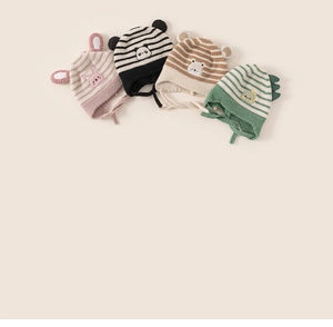 Detail of baby striped knit earflap hats with animal ears and soft chin straps
