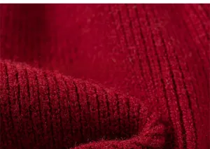 Close-up of soft red ribbed knit fabric on a girls' festive dress with thick texture