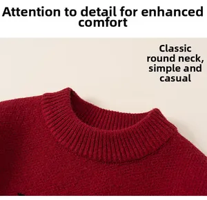 Detail view of the classic round neckline on this red knitted children sweater