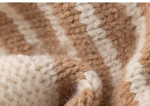 Close-up of soft brown and beige striped knit fabric texture on toddler winter hat