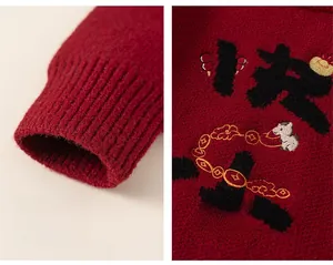 Detail of red festive knit sweater with ribbed cuffs and traditional Chinese embroidery