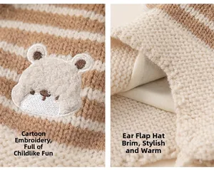 Close-up of knit baby earflap hat with cartoon bear embroidery and soft lining