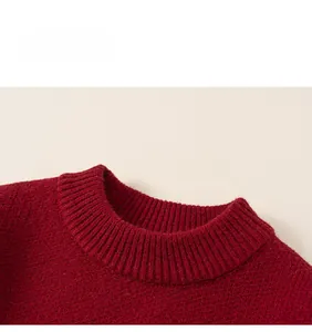Close-up of the ribbed crew neck and fine knit texture of this red festive sweater