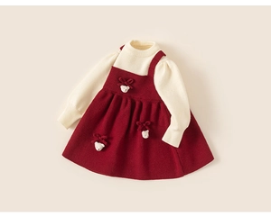 Detail of red knit dress for girls with cute white 3D bears and knitted texture