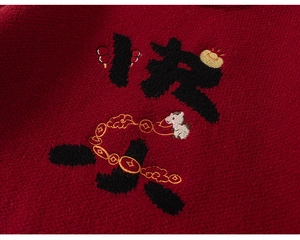Close-up of red knit sweater featuring festive horse embroidery and artful lettering