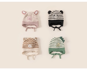 Detail of four baby knitted earflap hats with cute rabbit panda bear and dinosaur designs