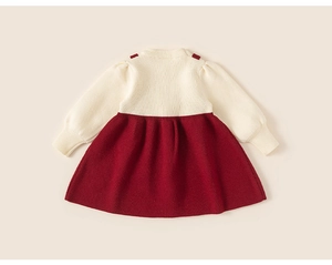Detail of knit contrast dress showing cream ribbed bodice and burgundy pleated skirt