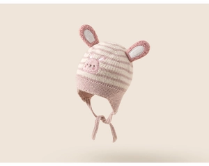 Close-up of pink striped knit baby earflap hat with cute bunny face and 3D ears