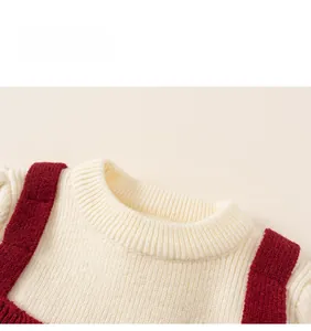 Detail of round neckline with cream rib-knit texture and red contrast straps for girls