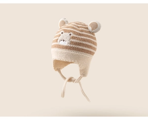 Close-up of baby knit earflap hat with bear embroidery and 3D ears detail