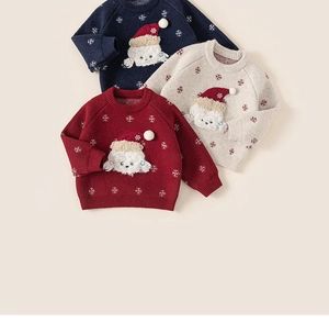 Flat lay of festive kids Christmas sweaters with snowflake patterns and puppy patches