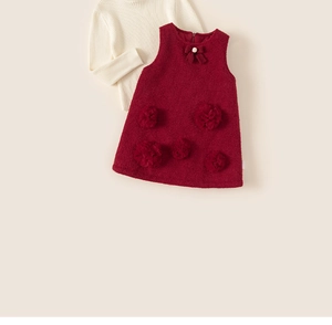 Detailed close-up of girls winter dress set featuring 3D floral accents and pearl bow tie