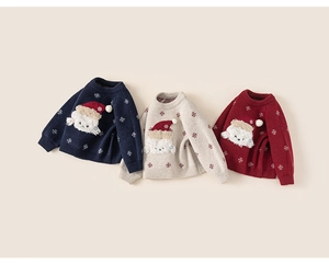 Detailed knit of children's sweaters in navy, cream, and red with polar bear and snowflakes