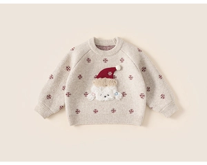 Detail of Christmas kids sweater with white dog patch and red snowflake knit patterns