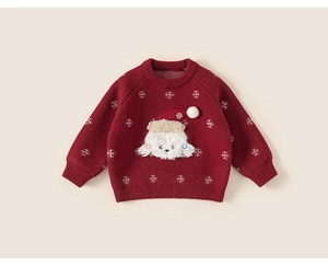 Close-up of red knit sweater featuring a white Christmas puppy patch and snowflakes