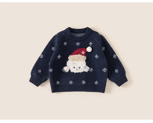 Detail of navy knit sweater with snowflake patterns and festive cartoon animal embroidery