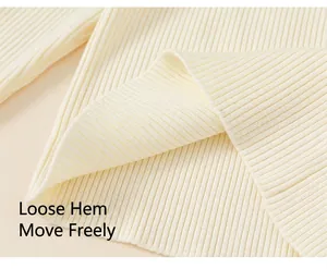 Close-up detail of cream ribbed knit sweater hem showing texture and loose fit design