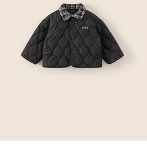 Detail of child's black quilted jacket showing checkered collar and BOBO embroidery