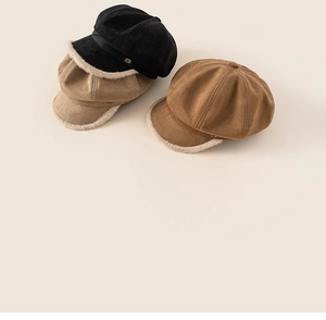 Detailed view of winter wool newsboy caps in black, khaki, and brown with faux fur trim