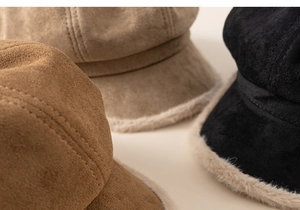 Detailed view of winter baker boy hats in brown, camel and black with faux fur lining
