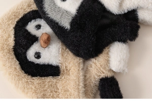 Detail of plush penguin-style winter hat featuring soft faux fur and cute 3D facial details