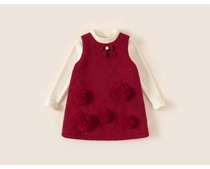 Close-up of girls' winter dress set with cream knit shirt and burgundy floral jumper skirt