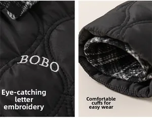 Detail of black quilted winter jacket featuring BOBO embroidery and plaid lining