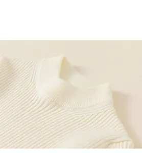 Detail view of the soft rib-knit neckline on this cream-colored winter sweater for girls