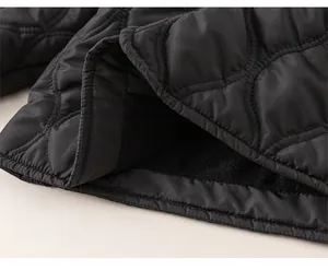 Detail of children's quilted jacket featuring a loose hem and warm fleece lining