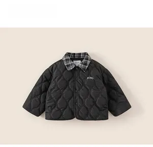 Close-up of kids black quilted jacket with checkered collar and BOBO embroidery detail
