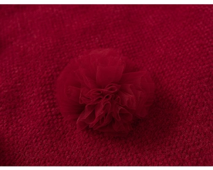 Detail of a red tulle floral 3D ornament on thick knit winter dress for young girls