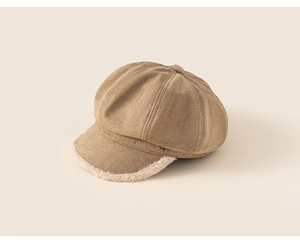 Detailed close-up of khaki suede baker boy hat with faux fur trim and metal R letter