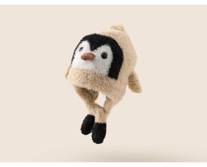 Detail view of plush beige penguin earflap hat with soft faux fur texture and bird beak