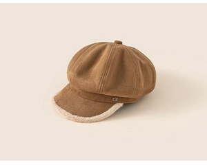 Detail of warm brown newsboy hat with soft faux suede texture and plush lamb wool trim