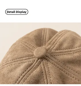 Macro detail of brown suede beret crown showing quality stitching and top button