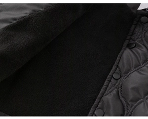Close-up of diamond quilted jacket with warm fleece lining and black metal snap buttons