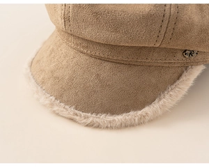 Close-up of khaki faux suede newsboy cap with plush trim and metal R letter emblem