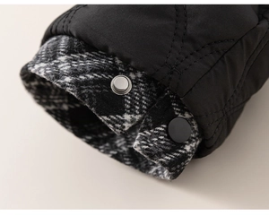 Detail of children quilted jacket cuff with diamond patterns and checkered lining