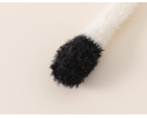 Close-up of soft black and white plush fabric texture on children winter hat