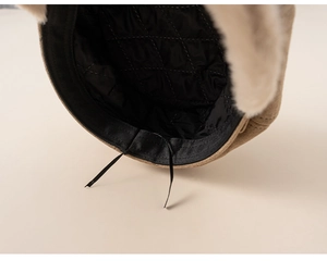 Close-up of beige beret featuring black quilted lining and adjustable inner drawstring