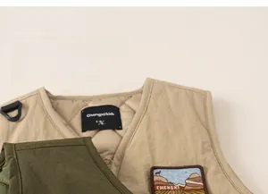 Close-up of quilted children's vest showing detailed stitching and outdoor embroidery