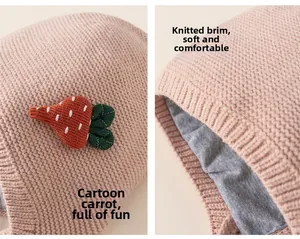Detail of pink knitted baby hat with cute carrot decor and soft cozy lining texture
