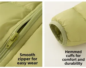 Detail of smooth zipper and elastic windproof cuffs on green hooded down jacket